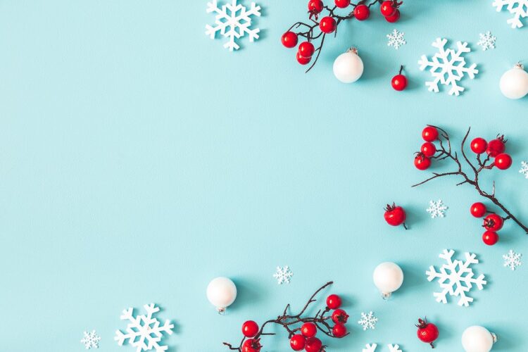 Christmas or winter composition. Snowflakes and red berries on blue background. Christmas, winter, new year concept. Flat lay, top view, copy space